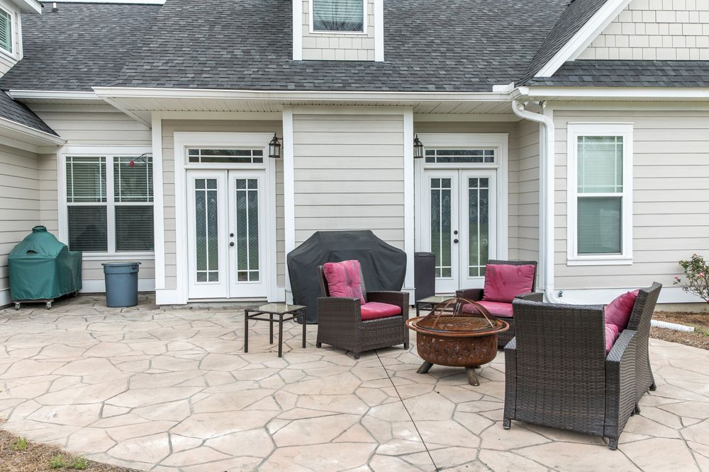 back patio of home stained with decorative flagstone patterns